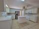 Bright kitchen with white appliances, a kitchen island, and ample counter space for food preparation and casual dining at 983 Noble Oak Ct, Lawrenceville, GA 30046