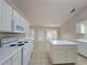 Well-lit kitchen featuring white cabinets and ample counter space, providing a clean and functional cooking area at 983 Noble Oak Ct, Lawrenceville, GA 30046