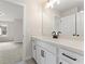 Well-lit bathroom with white cabinets, a white countertop, and a view into an adjacent room at 2722 Byess Ct, Marietta, GA 30064