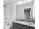 Bathroom with a shower/tub combo, tiled walls, a granite vanity, and chrome hardware at 3139 Stonegate Sw Dr, Atlanta, GA 30331