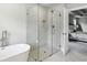 Bathroom featuring a glass-enclosed shower and a soaking tub next to an open doorway to the bedroom at 3139 Stonegate Sw Dr, Atlanta, GA 30331
