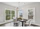 Elegant dining room with a modern chandelier and large windows offering scenic views at 3139 Stonegate Sw Dr, Atlanta, GA 30331