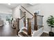 Bright entryway features hardwood floors, a staircase with dark wood banister and black iron spindles, and a view into the living room at 3139 Stonegate Sw Dr, Atlanta, GA 30331
