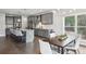 Open-concept kitchen and dining area featuring gray cabinetry, granite countertops, and stainless steel appliances at 3139 Stonegate Sw Dr, Atlanta, GA 30331