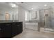 Elegant bathroom featuring a soaking tub, glass shower, and granite countertop at 8605 Gladden Ln, Suwanee, GA 30024