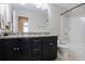 Bathroom with granite vanity, dual sinks, and a shower-tub combination at 8605 Gladden Ln, Suwanee, GA 30024