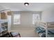 Comfortable bedroom with a bunk bed, bookcase, and neutral color scheme at 8605 Gladden Ln, Suwanee, GA 30024