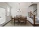 Traditional dining room with wood table, chandelier, and access to the backyard at 8605 Gladden Ln, Suwanee, GA 30024