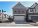 Charming two-story home with gray brick and two-car garage, set in a suburban neighborhood at 8605 Gladden Ln, Suwanee, GA 30024