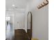Hallway features hardwood floors, a sleek full length mirror, and decorative coat rack at 8605 Gladden Ln, Suwanee, GA 30024
