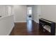 Hardwood floors in hallway leading to bedroom, featuring a piano on the right at 8605 Gladden Ln, Suwanee, GA 30024