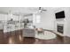 Open concept living room featuring a modern fireplace, dark hardwood floors, and recessed lighting at 8605 Gladden Ln, Suwanee, GA 30024