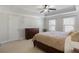 Bright main bedroom with a large bed, dresser, and natural light from two windows at 8605 Gladden Ln, Suwanee, GA 30024