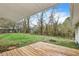 View of the backyard featuring a wood deck, partial grass coverage, and wooded perimeter at 10 Creek Se Dr, Cartersville, GA 30121