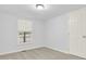 Neutral bedroom featuring a light fixture, window with blinds, carpet and a closet door at 10 Creek Se Dr, Cartersville, GA 30121