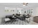 Modern living room with a comfortable gray sectional sofa and stylish geometric patterned rug at 10 Creek Se Dr, Cartersville, GA 30121