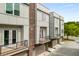 Exterior view of modern townhomes with brick accents and balconies above garages at 241 Maynard Se Ter # 15, Atlanta, GA 30316