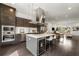 Bright kitchen features a large island with cooktop, wine fridge, stainless appliances, and dark wood cabinets at 241 Maynard Se Ter # 15, Atlanta, GA 30316