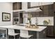 Modern kitchen boasts stainless steel appliances, sleek cabinets, large island, and beverage fridge at 241 Maynard Se Ter # 15, Atlanta, GA 30316