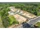 An aerial view showcases available lots in a new development, nestled among trees and featuring a neighborhood pond at 2719 Byess Ct, Marietta, GA 30064