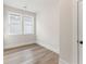 Bright bedroom featuring wood-look floors, white trim, and a window for ample natural light at 2719 Byess Ct, Marietta, GA 30064