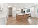 Bright kitchen featuring a center island, white cabinets, stainless appliances, and wood-look flooring at 2719 Byess Ct, Marietta, GA 30064