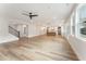 Open-concept living space with wood-look floors, a ceiling fan, and multiple windows providing abundant natural light at 2719 Byess Ct, Marietta, GA 30064