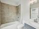 Bathroom with a shower/tub, gray-tile backsplash, and matching gray vanity cabinets at 3158 Stonegate Sw Dr, Atlanta, GA 30331