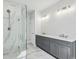 Modern bathroom featuring a double vanity, marble floors, and a glass-enclosed shower at 3158 Stonegate Sw Dr, Atlanta, GA 30331