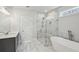 Bathroom featuring a glass shower, soaking tub, and double vanity with gray cabinets at 3158 Stonegate Sw Dr, Atlanta, GA 30331