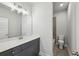 This bathroom has updated counters, cabinetry, and flooring with a water closet in the background at 3158 Stonegate Sw Dr, Atlanta, GA 30331