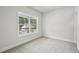 Carpeted bedroom showcasing a large window with natural light and neutral wall color at 3158 Stonegate Sw Dr, Atlanta, GA 30331