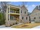 A two story home with a brick facade and yellow railings on the porch and balcony at 3158 Stonegate Sw Dr, Atlanta, GA 30331