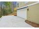 A well-lit two car garage with a neutral color and a large driveway in front at 3158 Stonegate Sw Dr, Atlanta, GA 30331