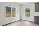 Bright kitchen nook with hardwood floors, a view of the backyard, and stylish gray cabinets at 3158 Stonegate Sw Dr, Atlanta, GA 30331