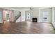 Open-concept living room featuring a staircase, fireplace, and plenty of natural light at 3158 Stonegate Sw Dr, Atlanta, GA 30331