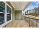 A cozy porch view with wooden floors, a wooden railing, and a scenic landscape at 3158 Stonegate Sw Dr, Atlanta, GA 30331