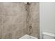 A tiled shower stall features a modern shower head and silver hardware at 3158 Stonegate Sw Dr, Atlanta, GA 30331