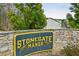 The Stonegate Manor community sign is presented in gold lettering and a stone wall at 3158 Stonegate Sw Dr, Atlanta, GA 30331