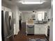 Bright and airy kitchen with white cabinets and stainless steel appliances overlooking the living room at 3571 Parc Sw Cir, Atlanta, GA 30311