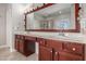 Bathroom features a double vanity, large framed mirror, and sconce lighting at 4525 Hopewell Manor Dr, Cumming, GA 30028