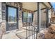 Inviting front porch with stone accents and a black front door, complete with iron railings at 4525 Hopewell Manor Dr, Cumming, GA 30028