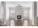 Bright living room with fireplace, large windows, and hardwood floors at 4525 Hopewell Manor Dr, Cumming, GA 30028