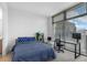 Cozy bedroom featuring a work space with a computer and a large window offering city views at 270 17Th Nw St # 2601, Atlanta, GA 30363