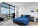 Modern bedroom with a desk near a window, offering city views and a comfortable bed at 270 17Th Nw St # 2601, Atlanta, GA 30363
