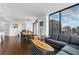 Spacious living room with a dining table, hardwood floors, and city views at 270 17Th Nw St # 2601, Atlanta, GA 30363