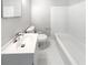 Classic bathroom with a clean white tub, toilet, and sink at 4679 Bartlett Rd, Forest Park, GA 30297
