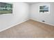 Cozy bedroom with carpeted floors, neutral paint, and bright windows at 4679 Bartlett Rd, Forest Park, GA 30297