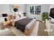 Staged bedroom featuring a large window, neutral paint and modern decor at 4679 Bartlett Rd, Forest Park, GA 30297