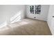 Cozy bedroom featuring a large window and neutral carpet at 4679 Bartlett Rd, Forest Park, GA 30297